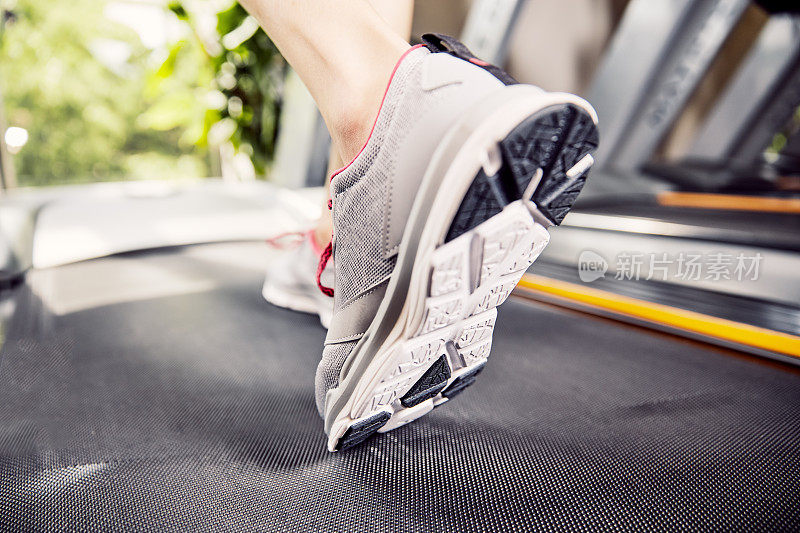 Fitness girl running on treadmill